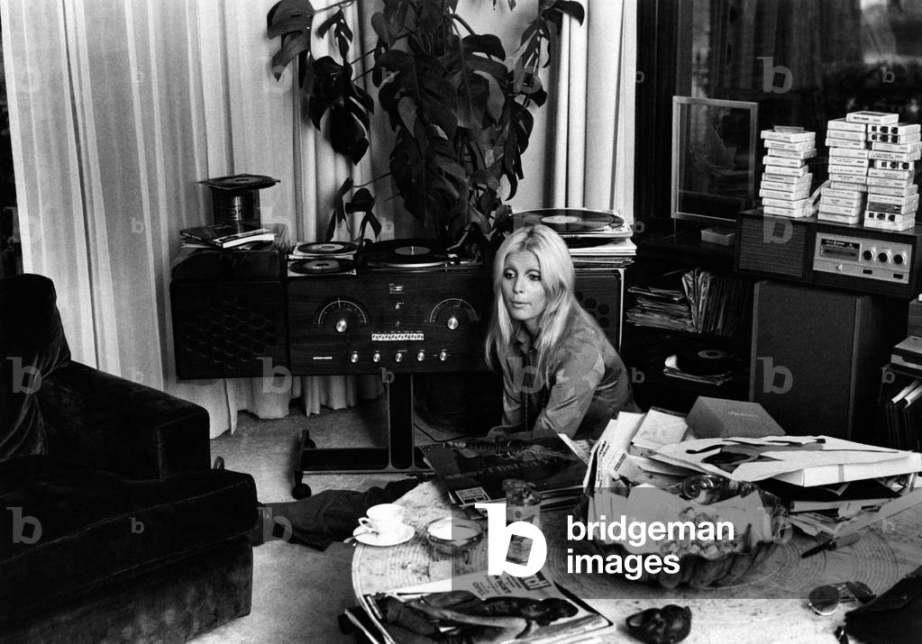 Patty Pravo posing near a record player