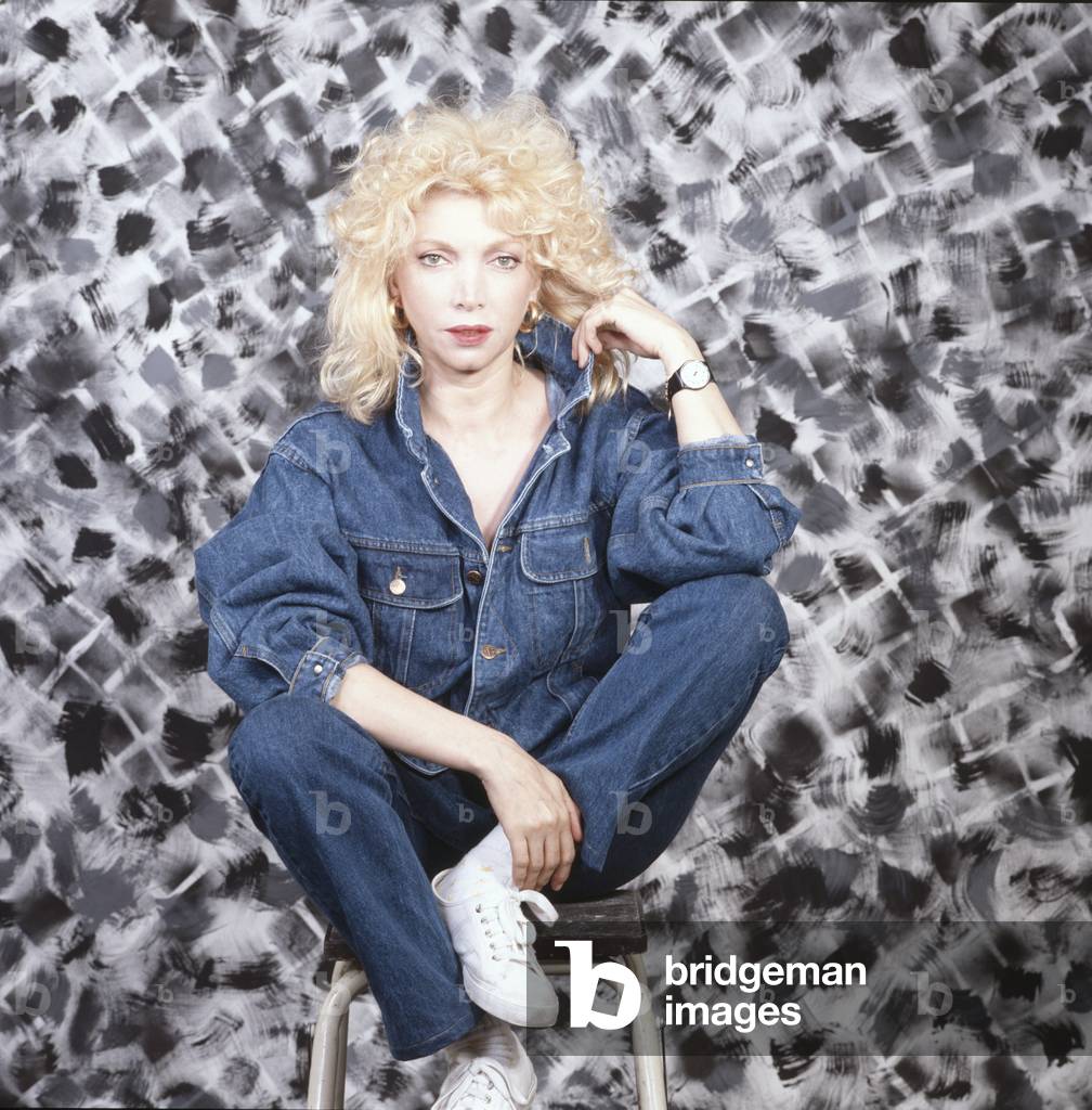 Mariangela Melato seated on a stool