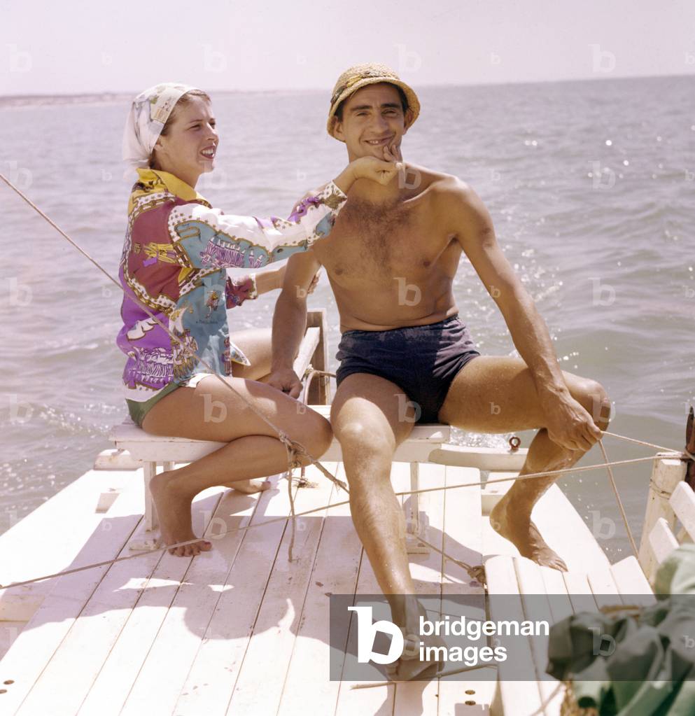 Walter Chiari, Italian actor, comician and TV host on the pedalo with the Italian actress Delia Scala, Italy, 1950 (photo)