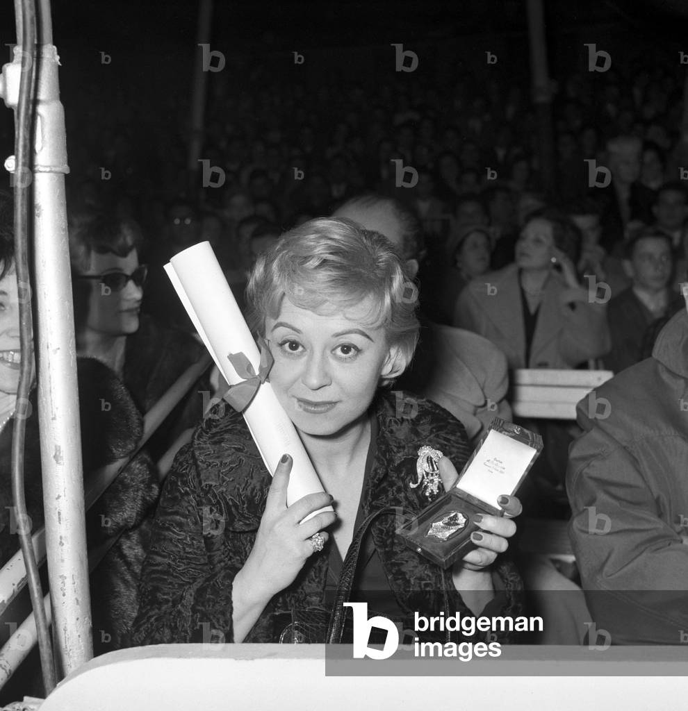 Giulietta Masina attending the Clown d'oro ceremony at the Orfei Circus, Italy, 1959 (b/w photo)