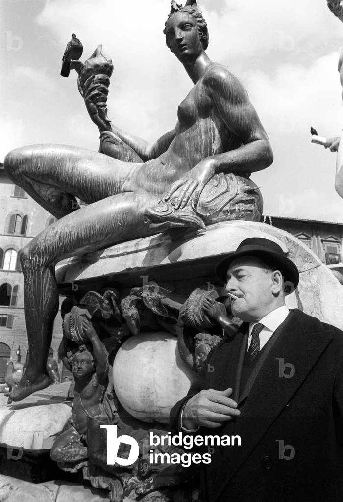 Salvatore Quasimodo smokes a cigarette under the Nereid of Giambologna