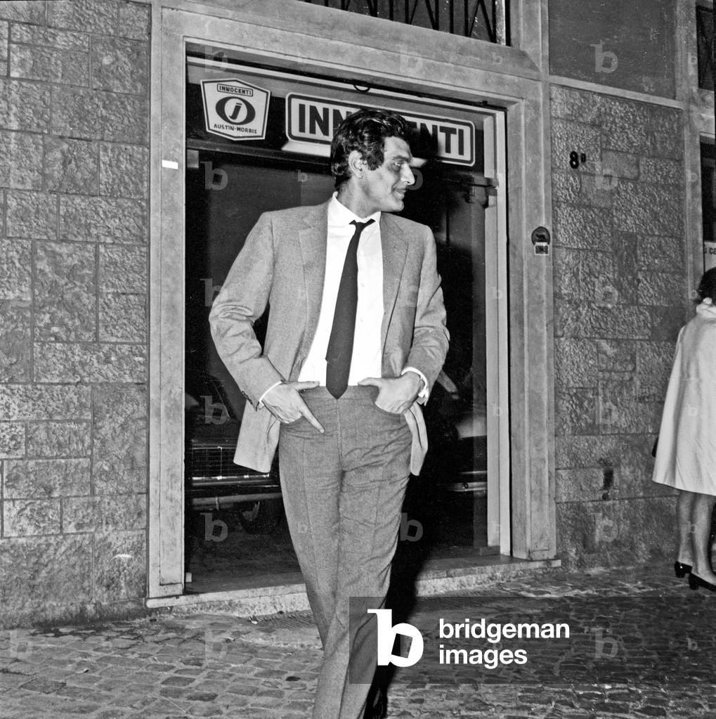 Omar Sharif walking through the street in Rome, Rome, Italy, 1968 (b/w photo)