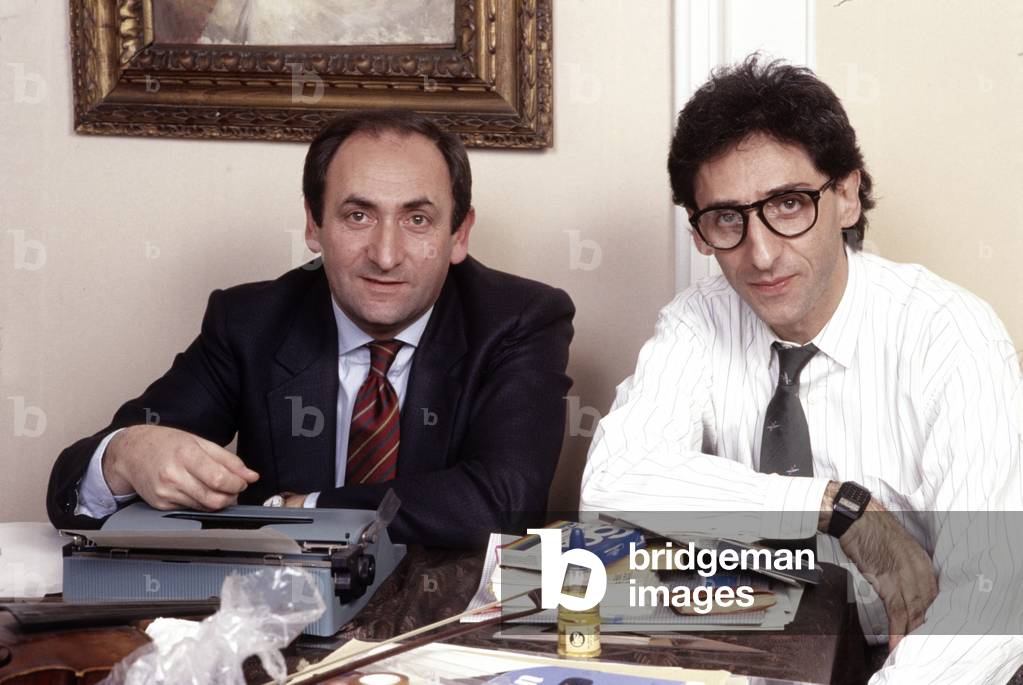 Michele Battiato and Franco Battiato sitting at the writing desk, Milan, Italy