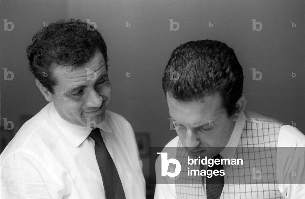 Enzo Tortora smiling at a colleague.