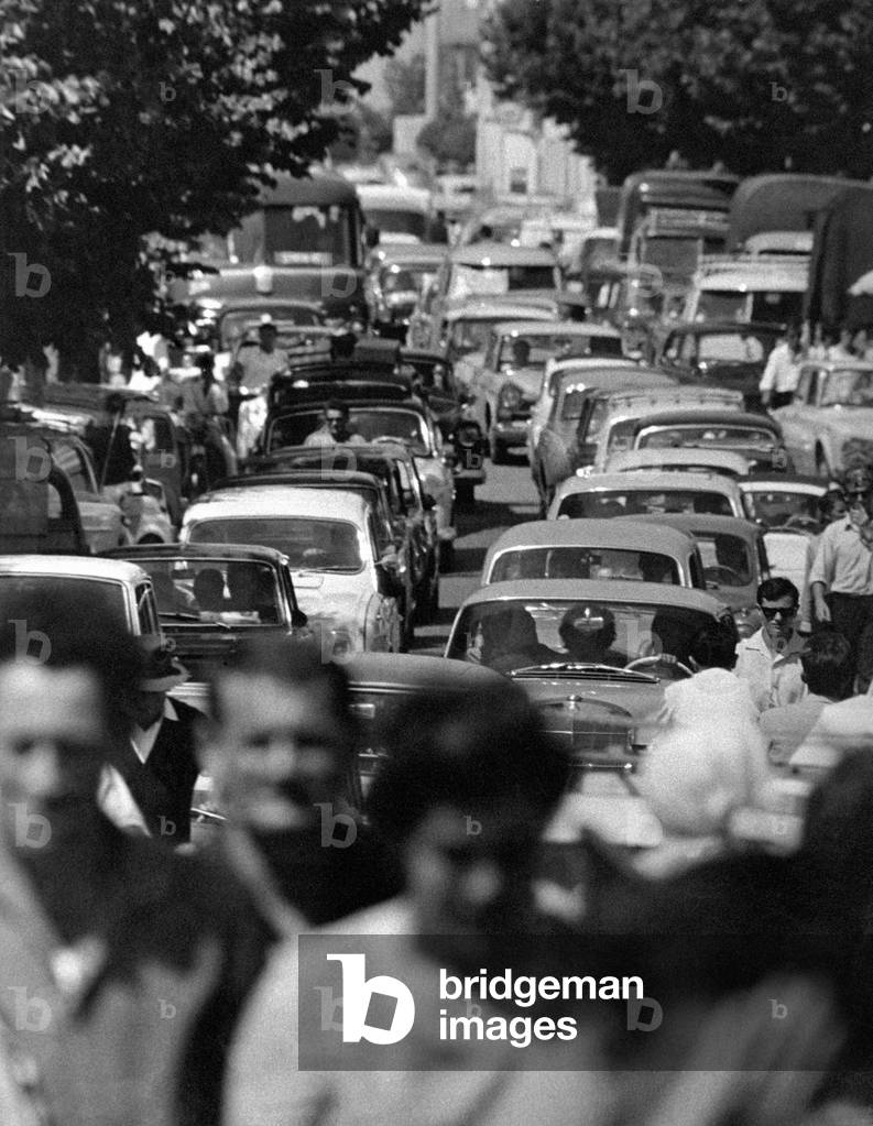 Wide shot on a congested street with passersby in the close-up, Jesolo, Italy