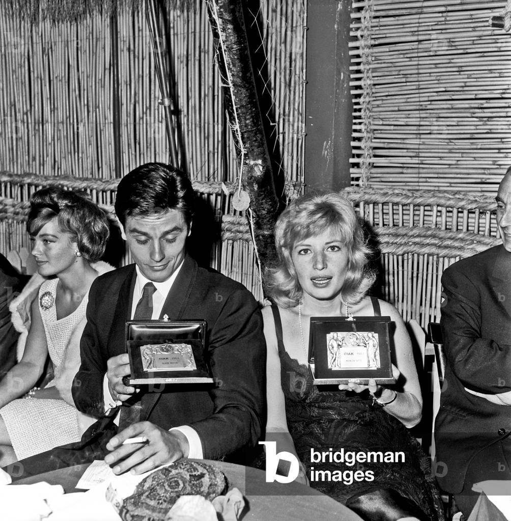 Alain Delon and Monica Vitti showing the 'Ciak d'oro' award, Rome, Italy, 1961 (b/w photo)
