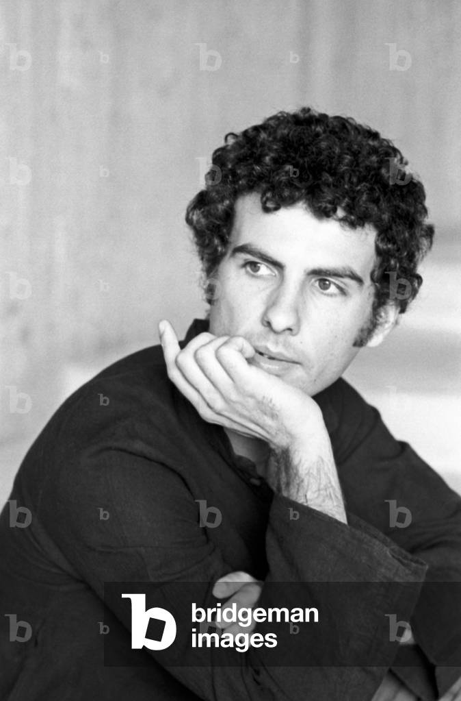 Andrea De Carlo posing with his hand under his chin