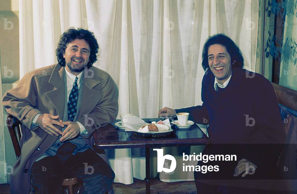 The comedian Beppe Grillo and the singer-songwriter Giorgio Gaber (Giorgio Gaberscik) having breakfast, 1990 (b/w photo)