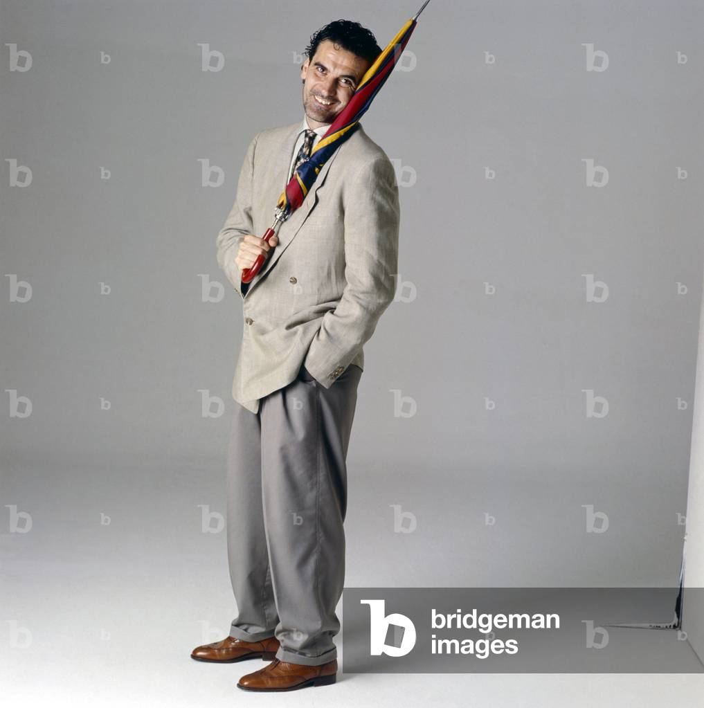 Massimo Troisi holding an umbrella, Italy