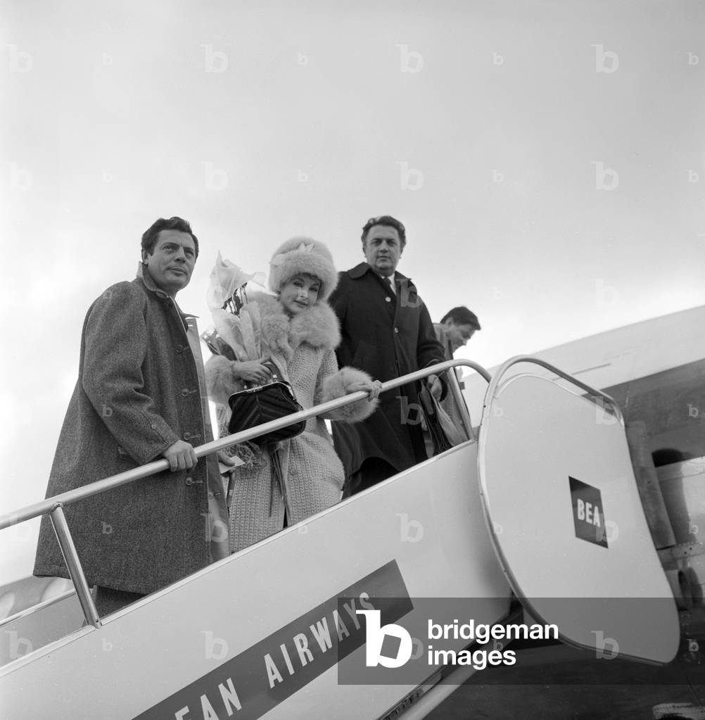 Federico Fellini, Marcello Mastroianni and Yvonne Furneaux flying to London, Italy, 1960 (b/w photo)