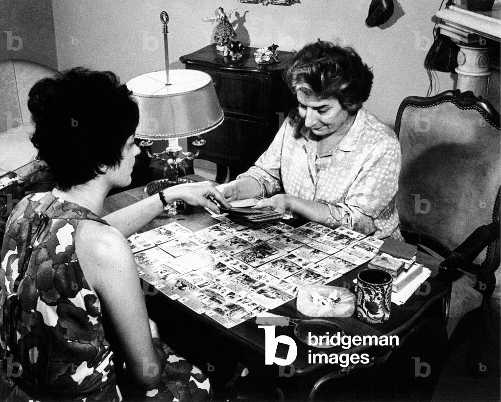 Maria Gardini gets a reading in the cards for a client, Rome, Italy