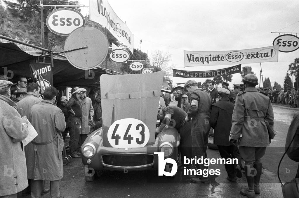 Mechanics checking the engine of a car, Italy