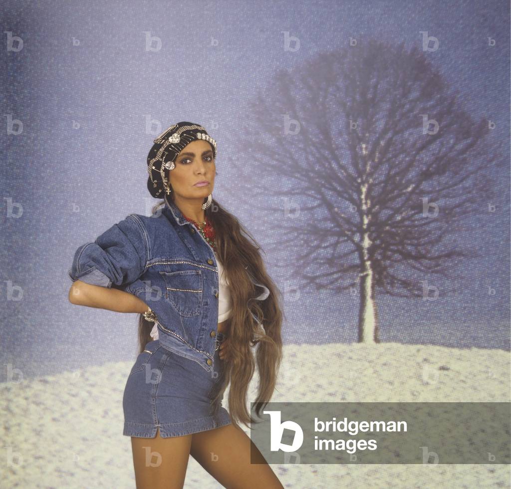 Loredana Berté posing with denim jacket and skirt, Italy