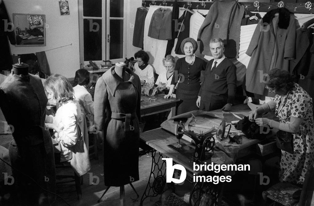 Biki in her workshop with a business partner and some seamstresses at work