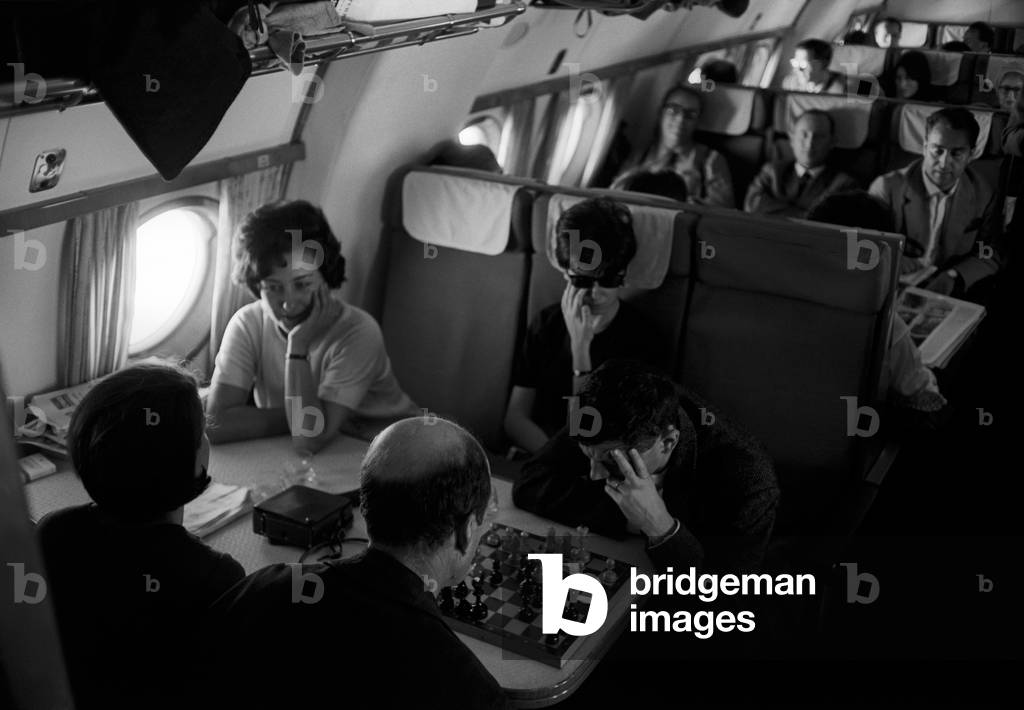 Some actors of the Teatro alla Scala company on a plane, 1964 (b/w photo)
