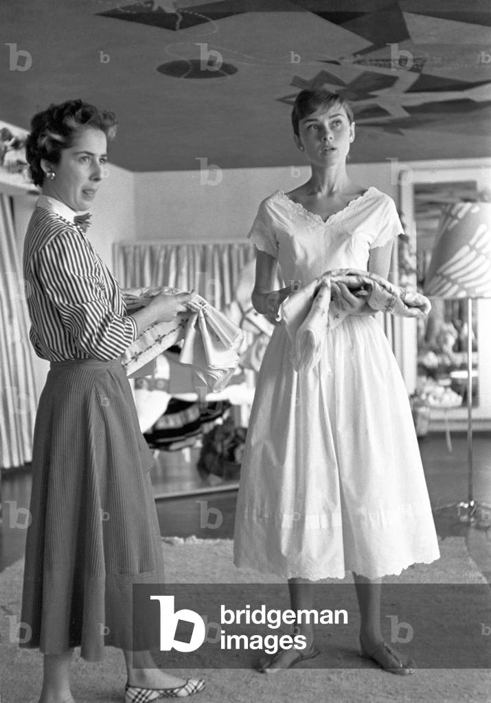 Audrey Hepburn in a fabric shop, Switzerland, Buergenstock, 1960 (b/w photo)
