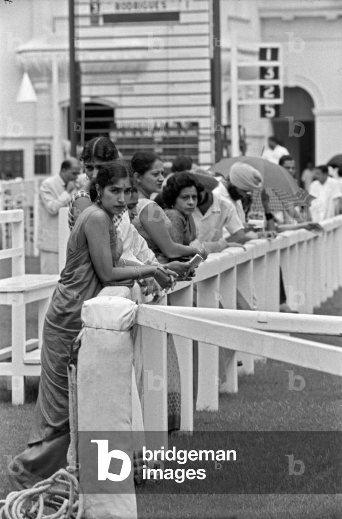 A group of women leaning on a fence, Kolkata, India, 1962 (b/w photo)