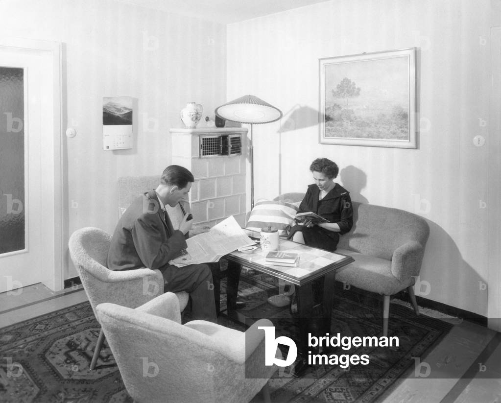 A man and a woman relaxing in the livingroom