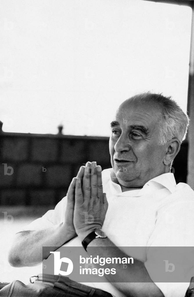 Luigi Longo sitting with clasped hands