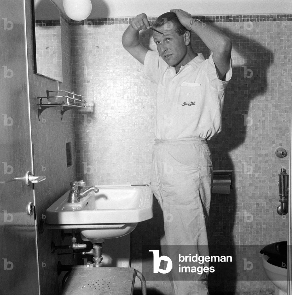 Peter Collins combing his hair, Italy