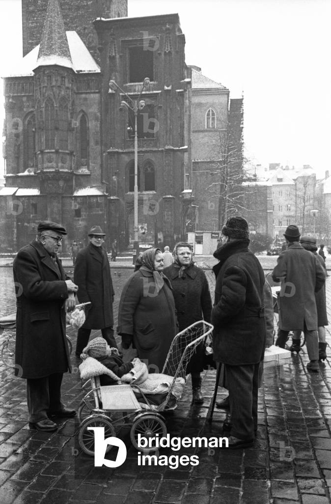 Some people chatting on Old Town Square, Prague, Czech Republic, December 1968 (b/w photo)