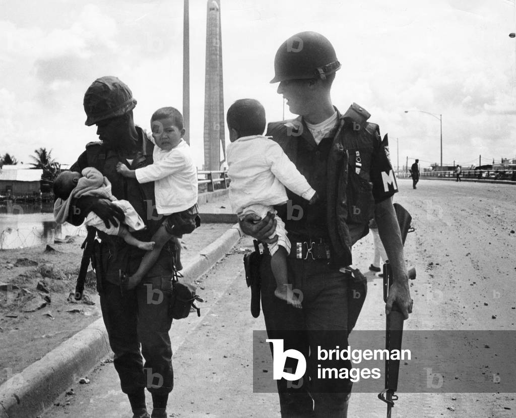 Two American soldiers with three children