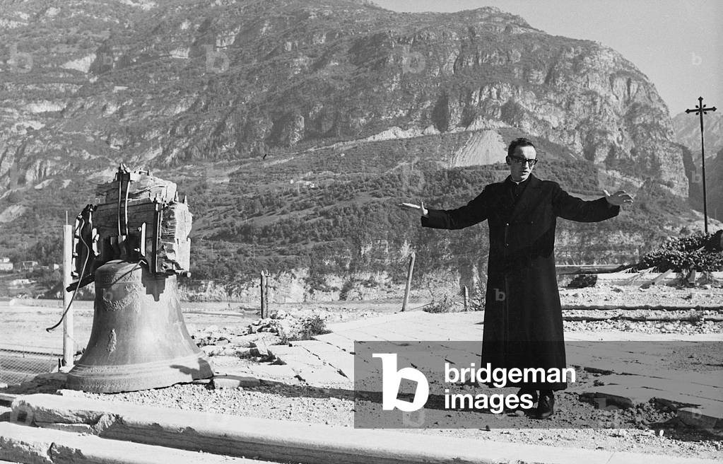 Vajont disaster, The parish priest of Longarone where his old church used to stand, The rebirth of the village damaged in 1963 has been stopped by a maze of laws, rules and administrative orders, Longarone, 11th October 1963 (photo)