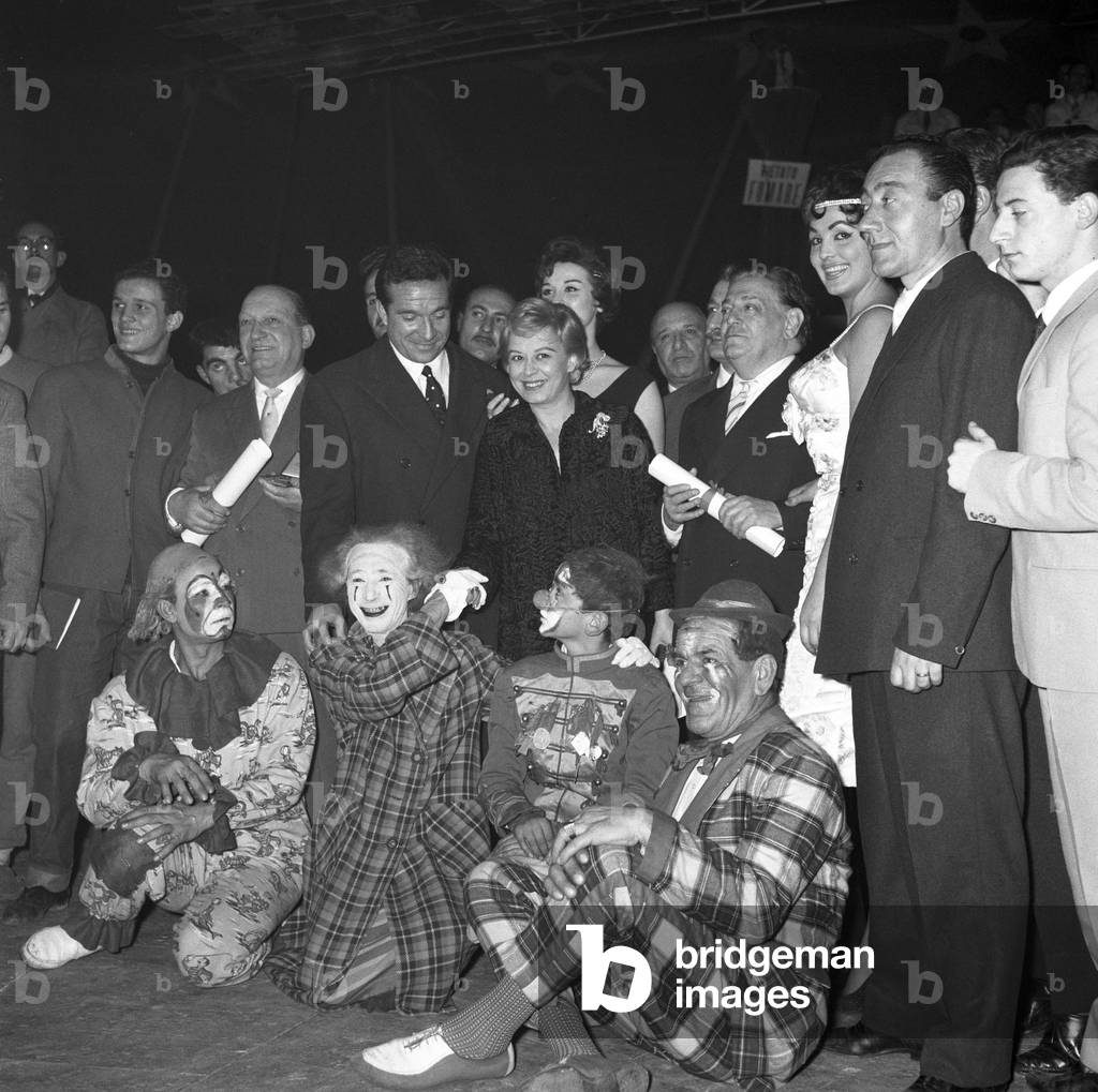 Giulietta Masina and Ugo Tognazzi attending the Clown d'oro ceremony at the Orfei Circus, Italy, 1959 (b/w photo)