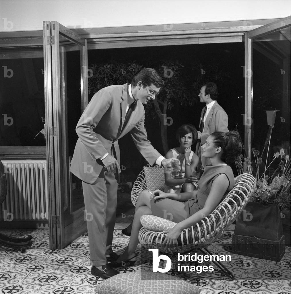A young man offering a drink to a girl, Italy