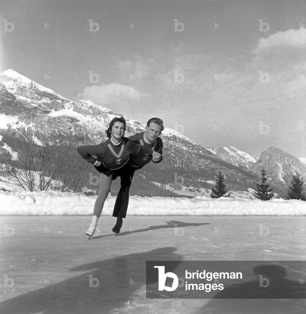 Figure skaters performing, Winter Olympics, Cortina d'Ampezzo, Italy, 1956 (b/w photo)