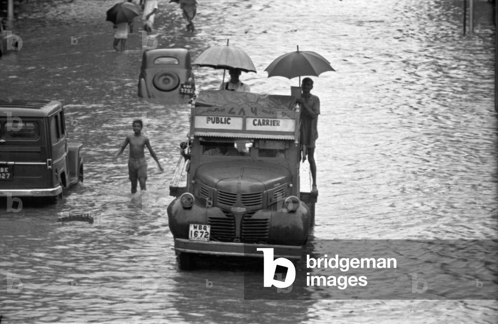 A van crossing a flooded street, Kolkata, India, 1962 (b/w photo)
