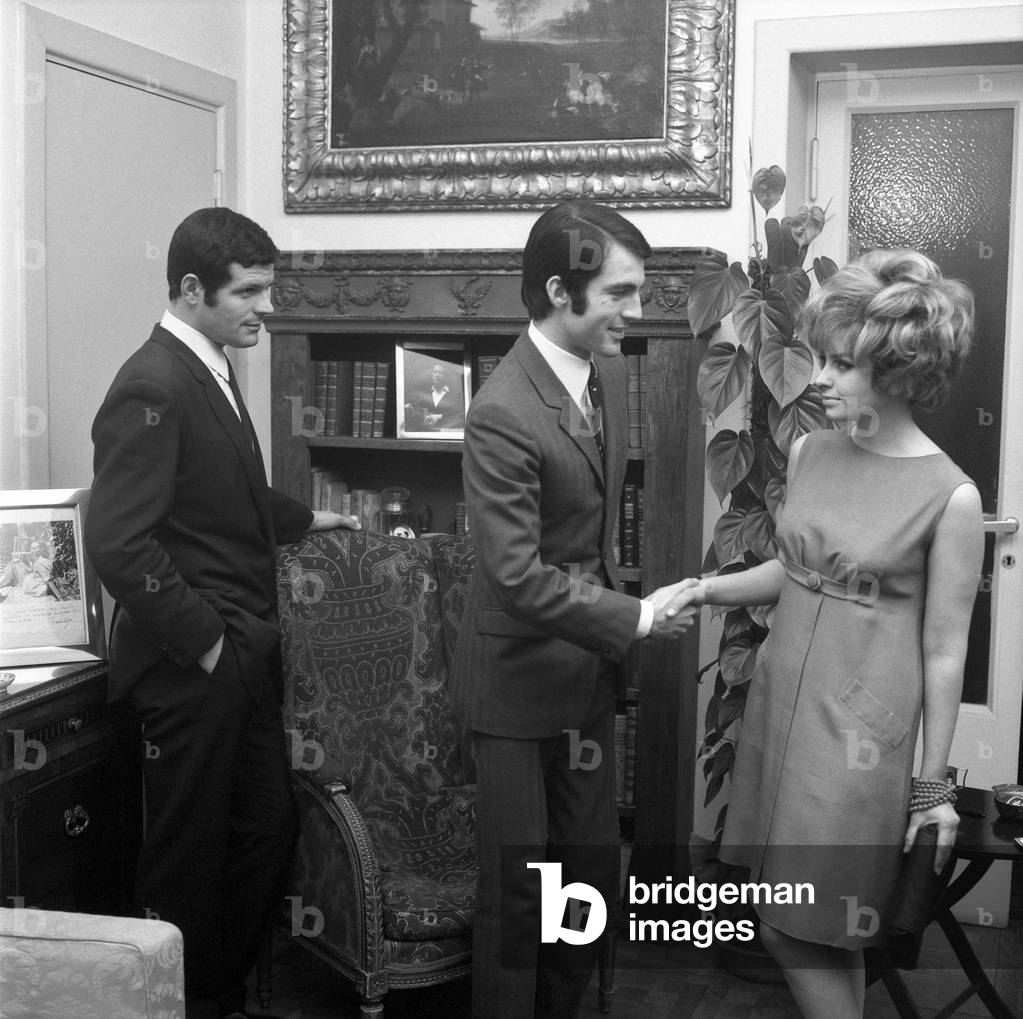 A young man shaking hands with a young woman, Italy