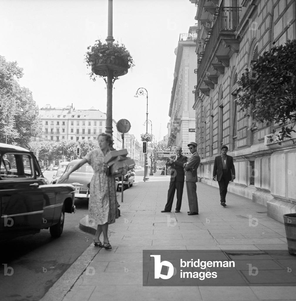 A woman getting off a car in Geneva, Geneva, Switzerland