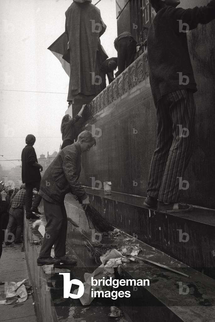 Young people are cleaning Saint Wenceslas Square in Prague