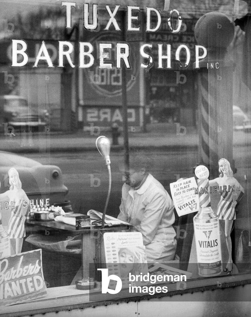 A woman reading in a Harlem shop