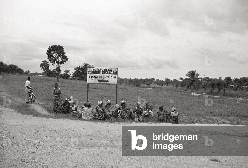 Some people sitting in the open air