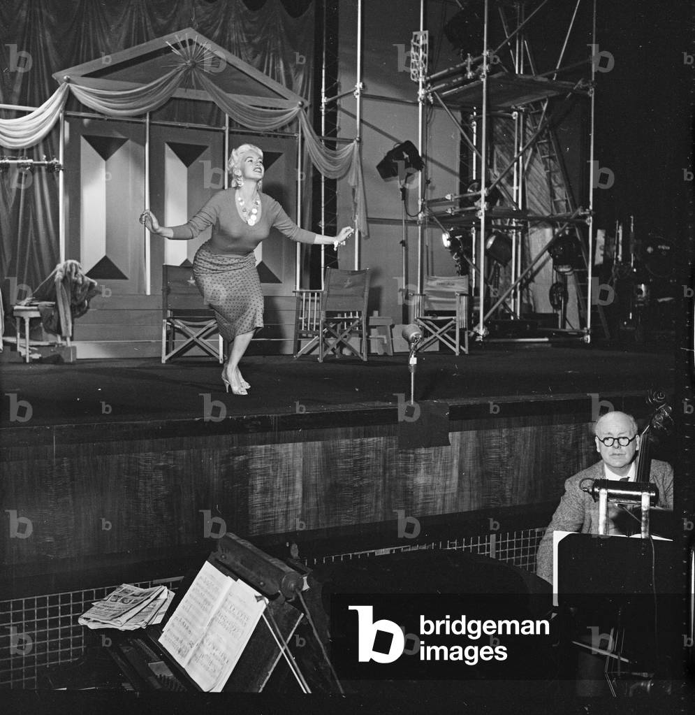 Jayne Mansfield rehearsing her curtsey to the Queen, Royal Film Performance, Granada TV, London, UK, 1958 (b/w photo)