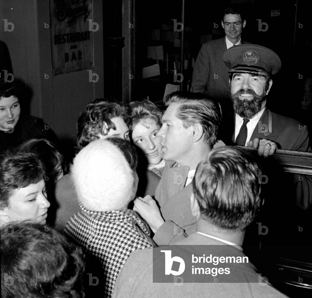 Johnny Ray with fans and doorman Tom, London, UK, 1954 (b/w photo)