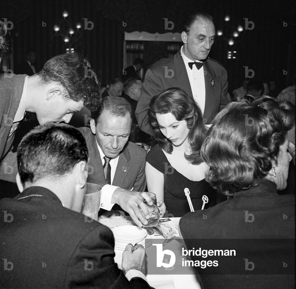 Frank Sinatra, Shirley Ann Field and Mike Kirsch, Pigalle 195, London, UK, 1955 (b/w photo)