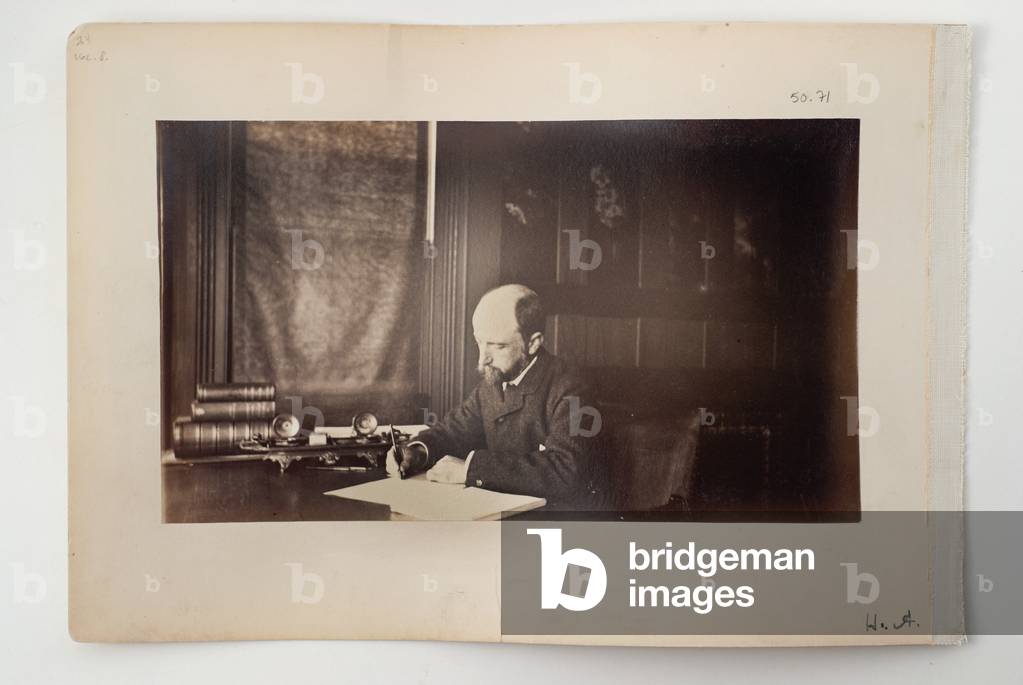 Henry Adams seated at a desk, 1883 (b/w photo)