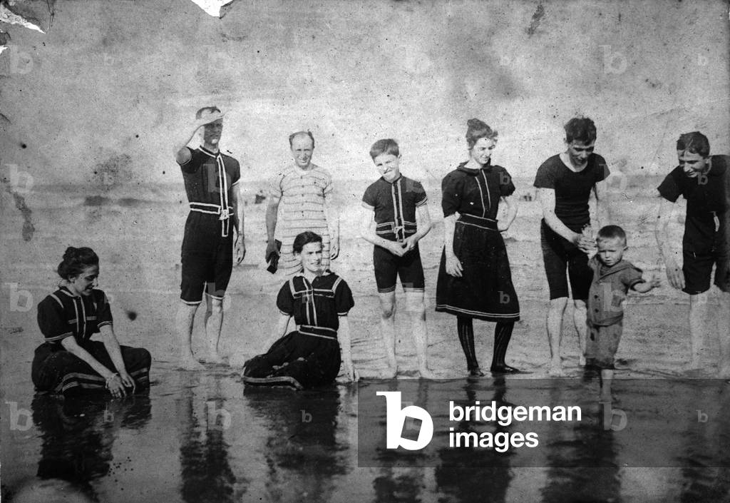 Edith Mercier (hand on hip) and others wade in shallow water, c.1898 (b/w photo)