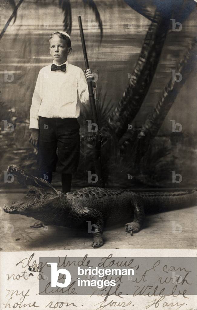 Harry posing with a stuffed alligator, c.1905 (b/w photo)
