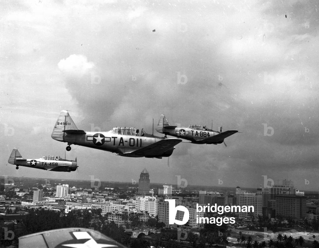 Three Air Force planes take part in a simulated air attack over downtown Miami, 1946 (b/w photo)