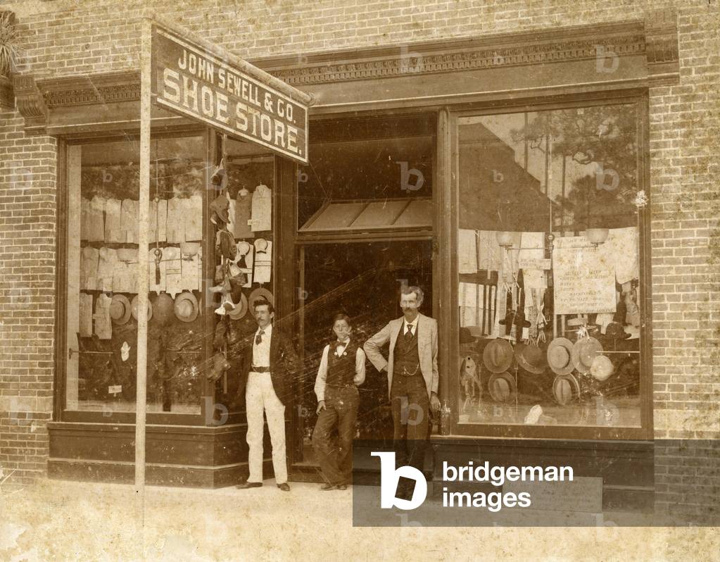 Store personnel in front of John Sewell & Co. Shoe Store, c.1910 (b/w photo)