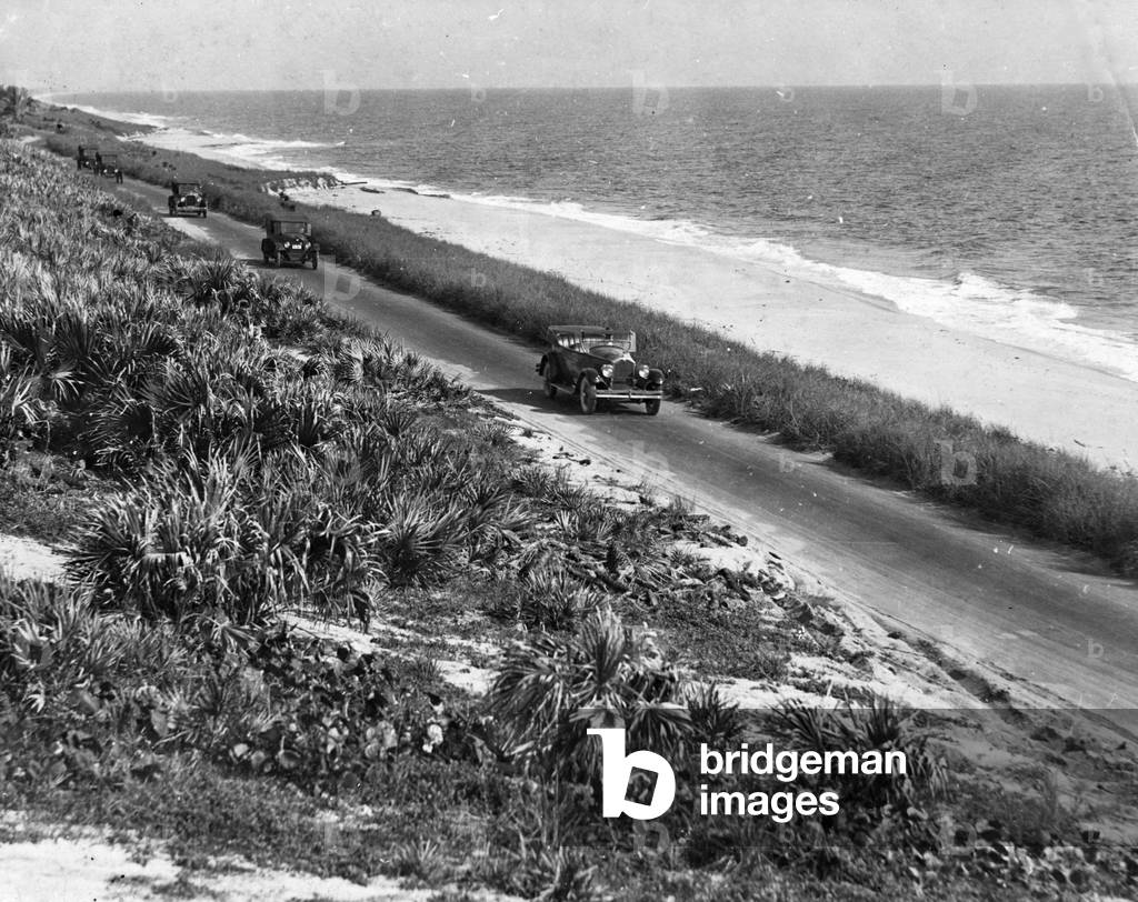 Motoring along on the Old Beach Road between Palm Beach and Miami Beach, 1925 (b/w photo)