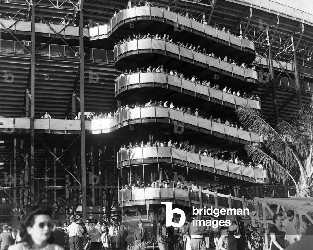 Sport fans leave the Orange Bowl Stadium via the exterior ramp after a game, Miami, 1947 (b/w photo)