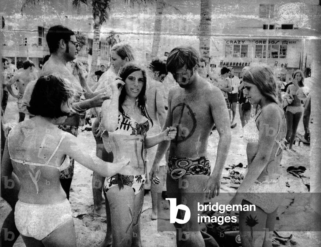 Body painting on the beach, 1969 (b/w photo)