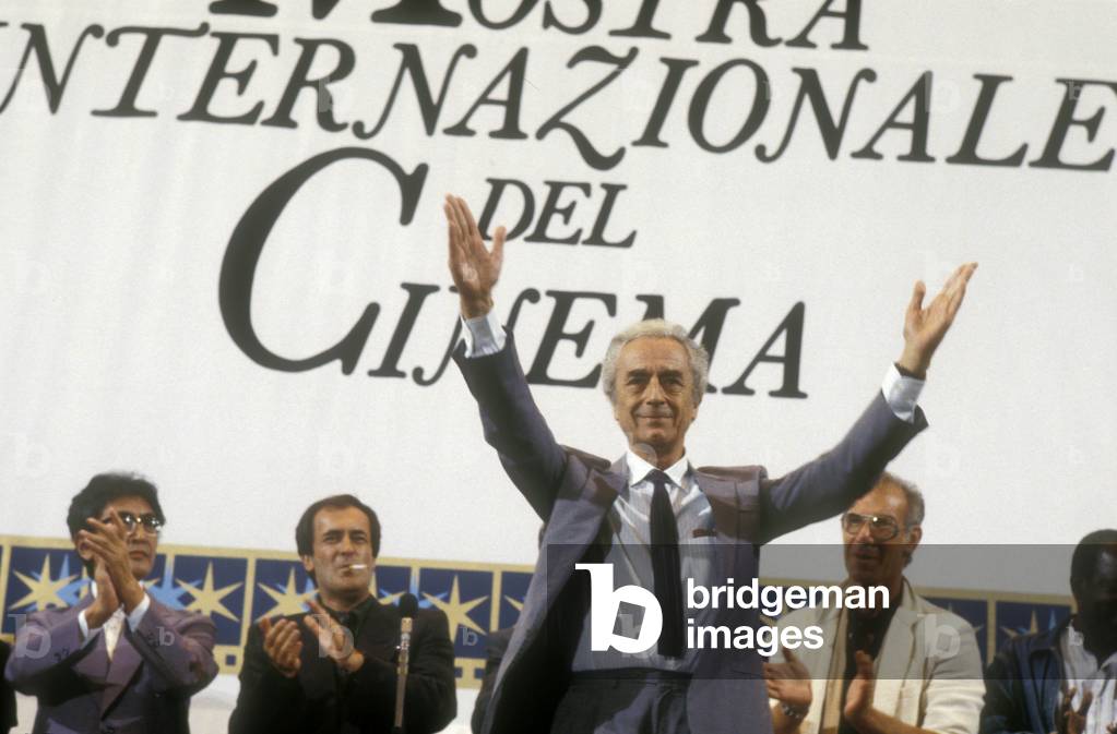 Venice Film Festival, 1983. Italian movie director Michelangelo Antonioni at the ceremony for his Golden Lion award for lifetime achievement (in the background, from the left, members of jury Nagisa Oshima, Bernardo Bertolucci and Bob Rafelson) (photo)
