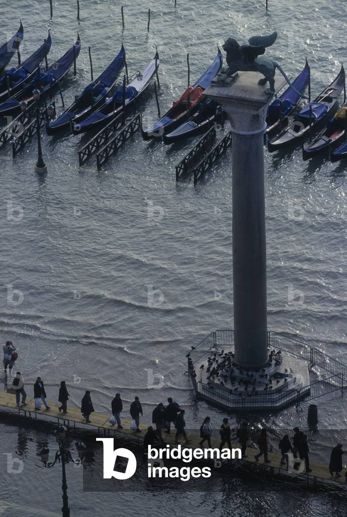 Venice, 1998. High Tide in St. Mark's Square. People walking on the gangways near the St. Mark's Column