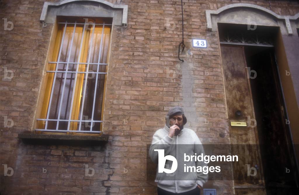 Bologna, 1985. Italian singer-songwriter Francesco Guccini in front of his house at via Paolo Fabbri 43 (photo)